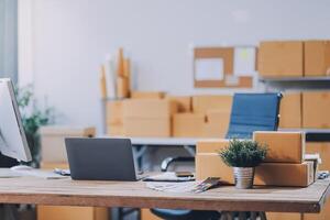 A desk with a laptop and boxes on it photo