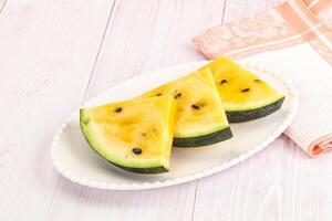 A white plate with slices of watermelon on it photo