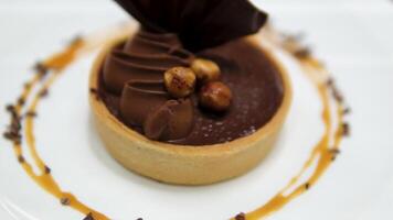 spinning delicious tartlets with buttercream and caramel with nuts, fresh delicious cake spinning on the table video