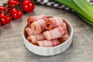 Bacon wrapped in bacon in a bowl on a table photo