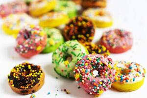 Set of various colorful donuts isolated on white background. Top view. photo