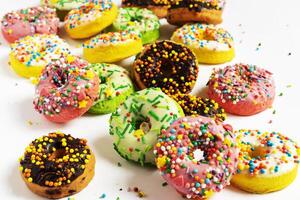 Set of various colorful donuts isolated on white background. Top view. photo