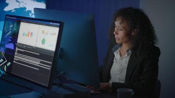 A Focused Professional Dedicating Efforts to Working on Advanced Technology Within a Dim Environment video