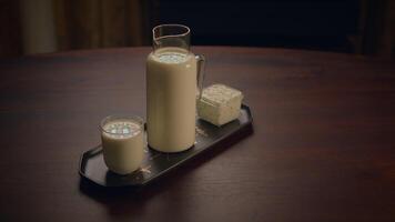 A mouthwatering setup of milk and cookies beautifully arranged on a charming rustic table video