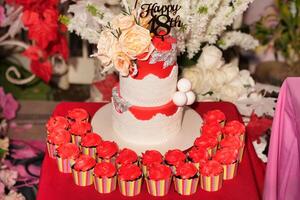a red table cloth with a birthday cake on top photo