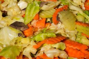 a close up of a salad with carrots, cabbage, and mushrooms photo