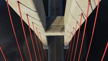 Drone flight over the support of the bridge built across the sea strait at dawn video