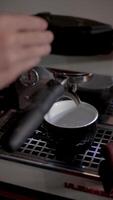 Barista Turning On Coffee Machine And Brewing Espresso Directly Into A Glass For A Freshly Made Hot Beverage In Cafe Environment. video