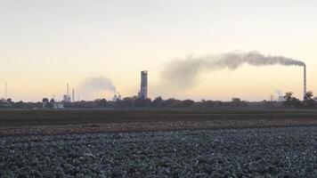 Heavy gray smoke is poured from the chimney pipes of thermal power plant. Carbon dioxide emitting from chimneys from industrial factory into the atmosphere. Concept of environmental pollution problem photo