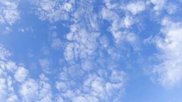Camera move behind white fluffy clouds on blue sky at summer sunny day. Beautiful nature background. Close up Slow motion photo