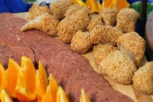 a cutting board with sliced oranges, meat and rice covered with crushed peanuts photo