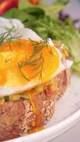 Delicious brunch dish featuring poached egg and fresh salad served in a cozy cafe video