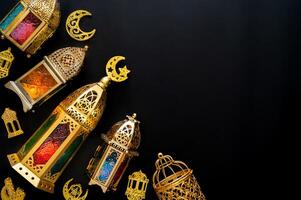 Golden lanterns with light put on black background for the Muslim feast of the holy month of Ramadan Kareem. photo