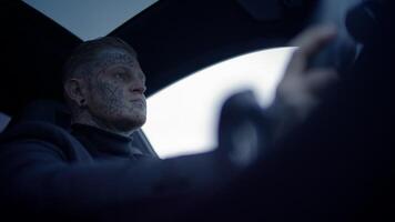 An Intense Profile of a Skilled Driver Taking the Wheel in a Stylish and Modern Car Design video