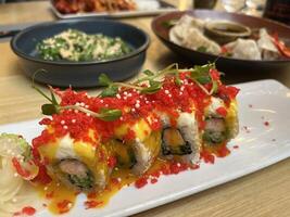 Red Dragon Sushi. Sushi with salmon, panko tiger prawns, cucumber, unagi sauce, mayonnaise, sesame seeds in Japanese restaurant photo