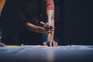 Two people working on a project at a table photo