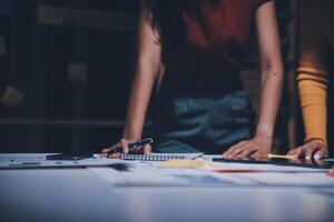 Two people working on a project at a table photo