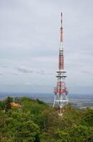 Radio tower on hilltop in spring photo