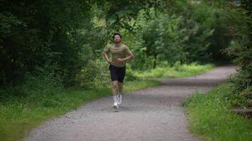 A person enthusiastically running along a beautiful scenic trail surrounded by nature video