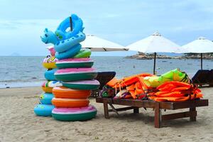 Life vests and lifebuoys on the beach of South China sea of Vietnam Nha trang photo