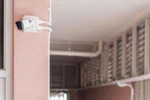 Security Camera on Building. IP CCTV camera install by have water proof cover to protect camera photo