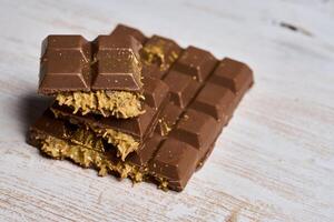 A piece of chocolate with a piece of gold on it photo