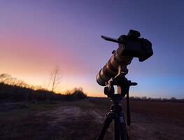 A tripod with a camera on it photo