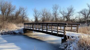 Wooden Bridge Over a Frozen Creek photo