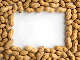 frame made of peanuts on a white background photo