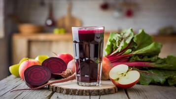 Bold red beet and apple juice on a rustic wooden table photo