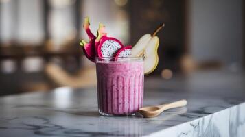 Vibrant dragon fruit pear smoothie on marble countertop with wooden spoon photo