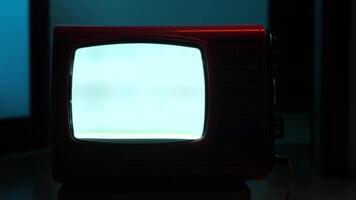 Old analog television showing static noise in dark room video