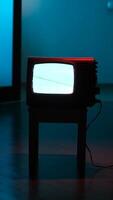 vertical Old analog television set displaying static white noise in dark room video