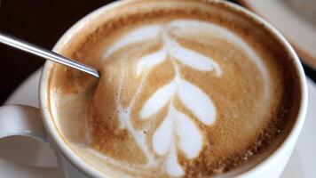 Discover latte art techniques in a cozy cafe setting video