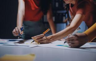 Three people working on a project at a table photo