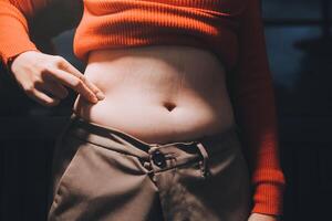 A woman with a large belly and a red sweater photo