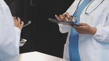 Two doctors are talking on a tablet video