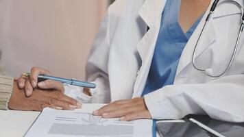 A doctor is writing on a paper with a pen video
