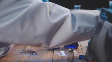 A person in a lab coat is working on something video