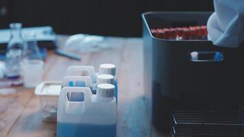 A person in a lab coat is holding a container video