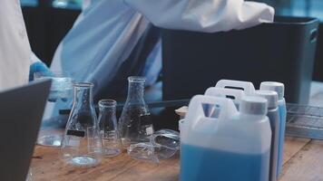 A man in a lab coat is working on a computer video