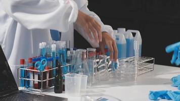 A person in a lab coat is working on a computer video