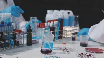 A group of people in lab coats are working on a project video