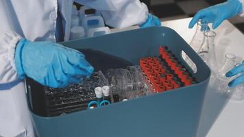 A person in a lab coat is holding a container video