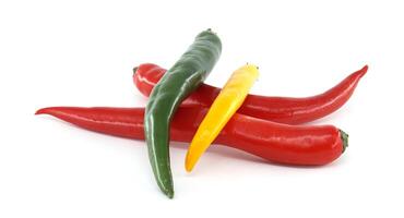 Colorful chili peppers creating a vibrant arrangement on white background photo