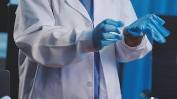A person in a lab coat and gloves is holding something video