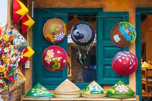 Vietnamese painted hats Non La are sold for tourists as souvenirs. Da Nang, Vietnam - November 30, 2024. photo
