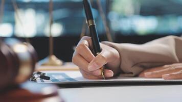 Lawyer writing on paper with pen and gavel video