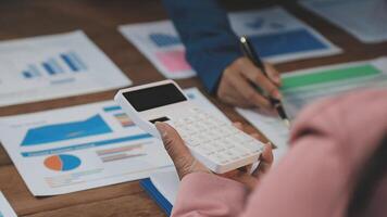 Business people using calculator to calculate the cost of a project video
