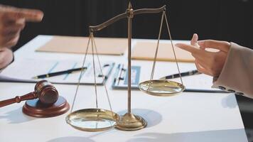 A lawyer and a judge are holding a scale with two scales video